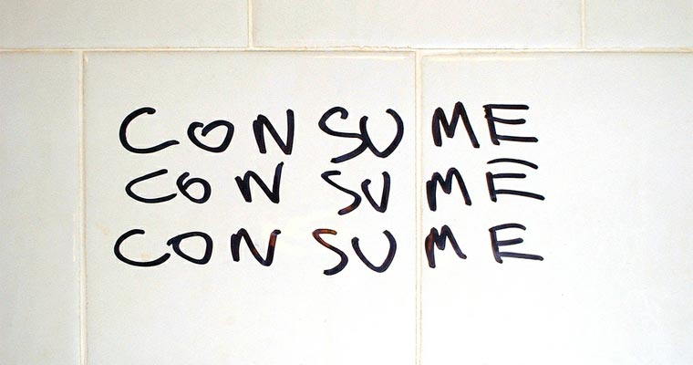 Consume graffiti on toilet wall