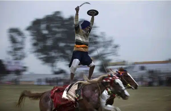 Rural Olympics Man riding two horses Rural Olympics Man riding two horses