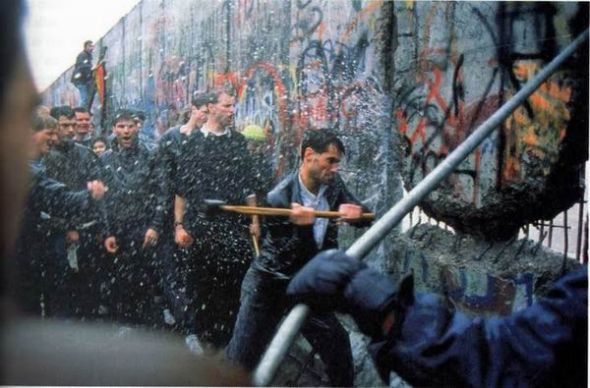 man destroying berlin wall