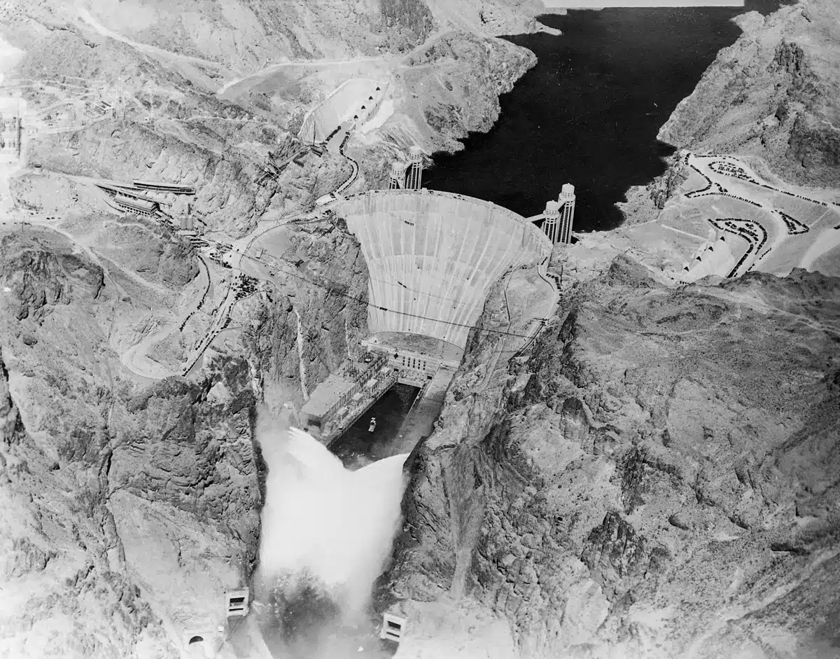 12 Sep 1936, USA --- Original caption: 9/12/1936-Boulder Dam, AZ/NV- An electrical impulse released by President Roosevelt pressing a button across the continent sent 3,600,000 cubic feet of water a minute tumbling through Gigantic Boulder Dam, and put the Colorado River to work generating electrical power. This photo made by Albert Kopec from a Richfield Oil Company plane, shows the Niagara of water from the 12 outlets; six on the Nevada side and six on the Arizona side. --- Image by © Bettmann/CORBIS