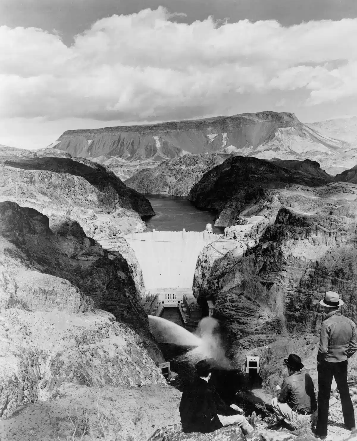 1940, Arizona, USA --- Men take in the view of the Boulder Dam and Lake Mead from the Nevada side of the Colorado River. | Location: Border of Arizona and Colorado, USA. --- Image by © Schenectady Museum; Hall of Electrical History Foundation/CORBIS