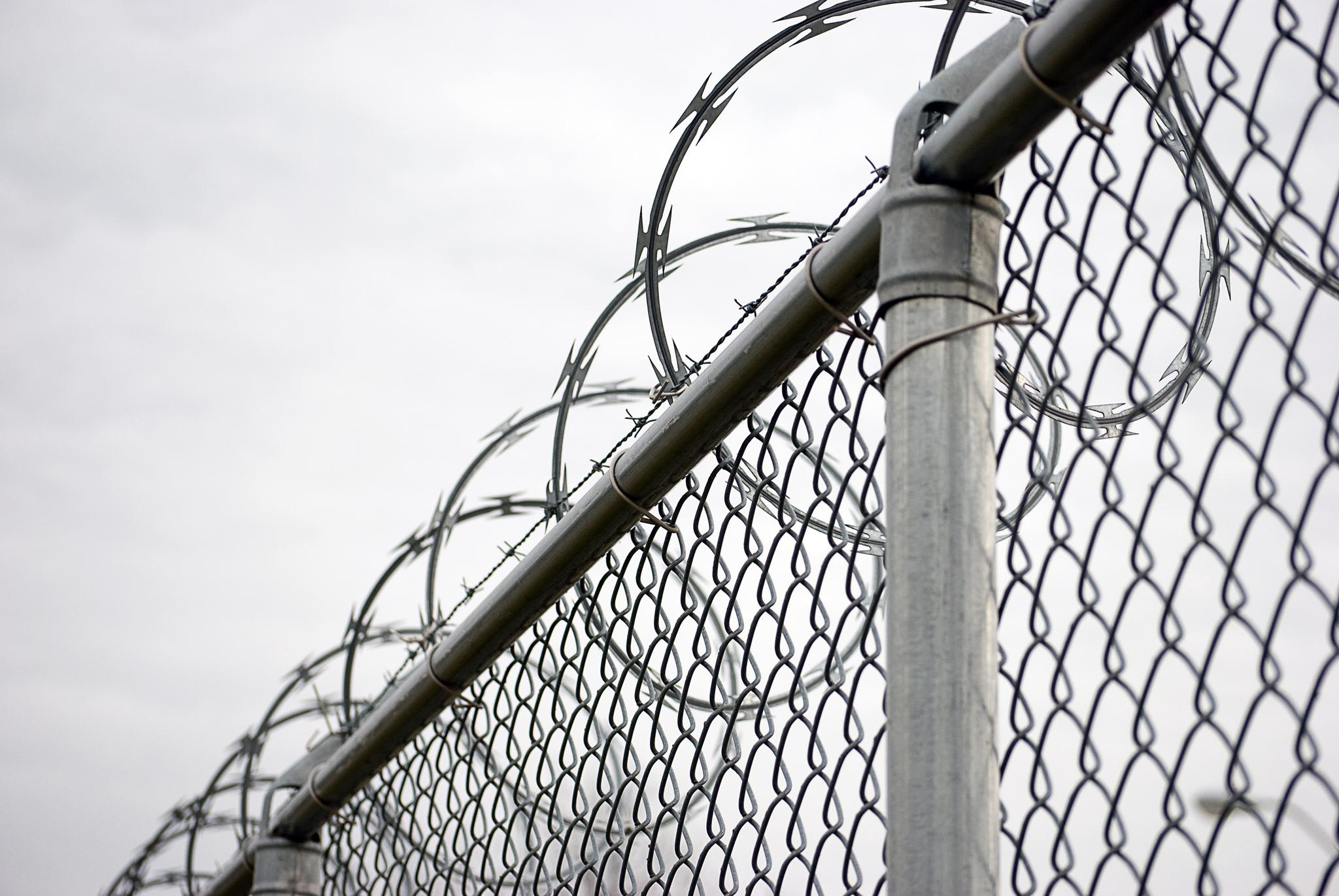 Chain link fence with razor wire on top