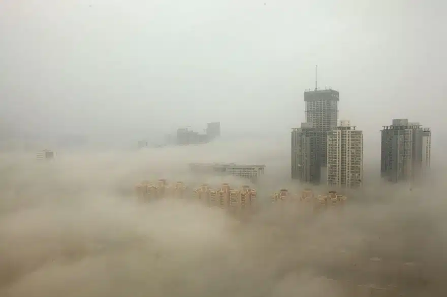 LIANYUNGANG, CHINA - DECEMBER 08: (CHINA OUT) Buildings are shrouded in smog on December 8, 2013 in Lianyungang, China. Heavy smog has been lingering in northern and eastern parts of China since last week, disturbing the traffic, worsening air pollution and forcing the closure of schools. (Photo by ChinaFotoPress/Getty Images)