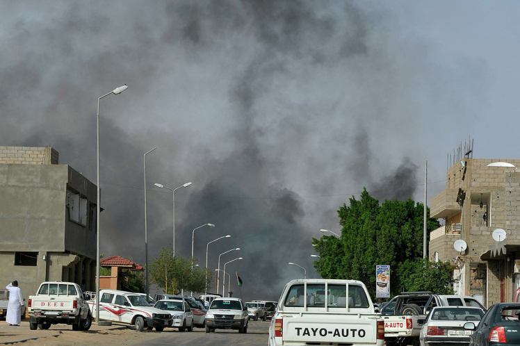 Smoke rises from a road in the district