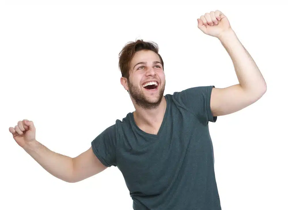 man cheering with arms outstretched