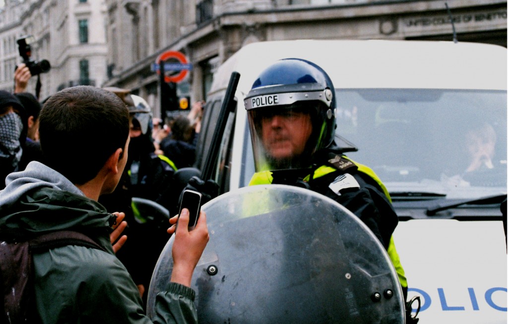 march 26 police raises baton to protestor