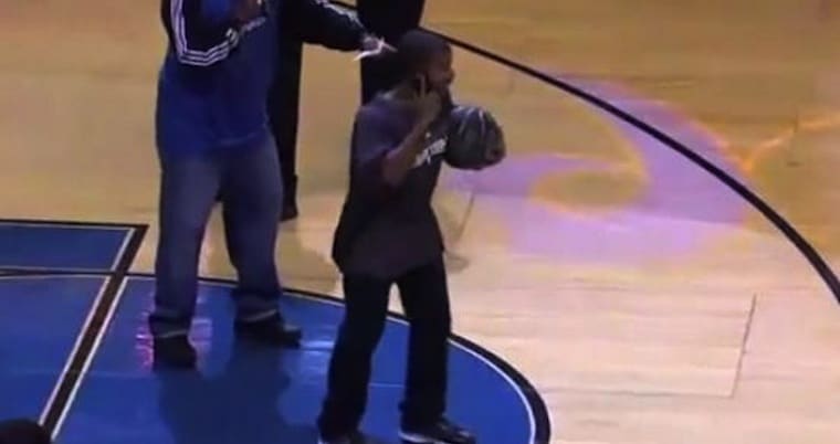 BASKETBALL FAN SMASHES MASCOT