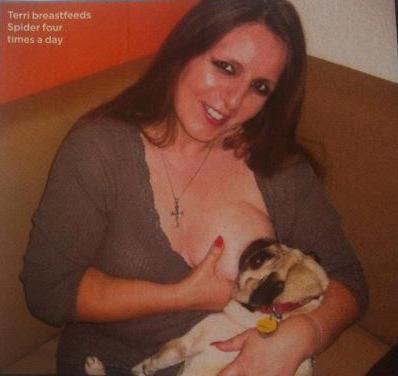 woman breastfeeds dog