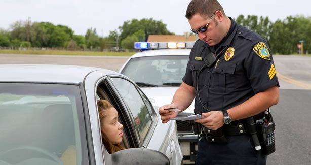 Policeman Pulling Over Car