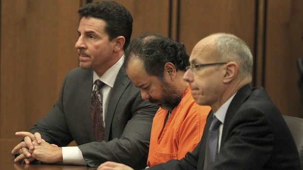 Ariel Castro, 52, sits with his head down between his attorneys Jaye Schlachet and Craig Weintraub during his pre-trial hearing in Cleveland