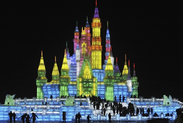 People visit an ice sculpture for the upcoming 25th Harbin International Ice and Snow Festival at a park in Harbin