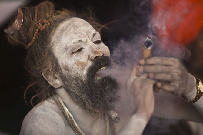 Kumbh Mela - Sadhu smokes marijuana