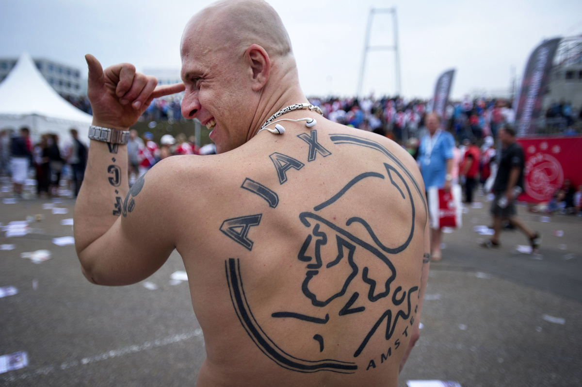 An Amsterdam Ajax football fan shows off