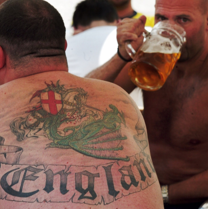 ENGLAND FANS DRINK BEER ON A CAFE TERRACE AT FIGUEIRA SQUARE IN LISBON.