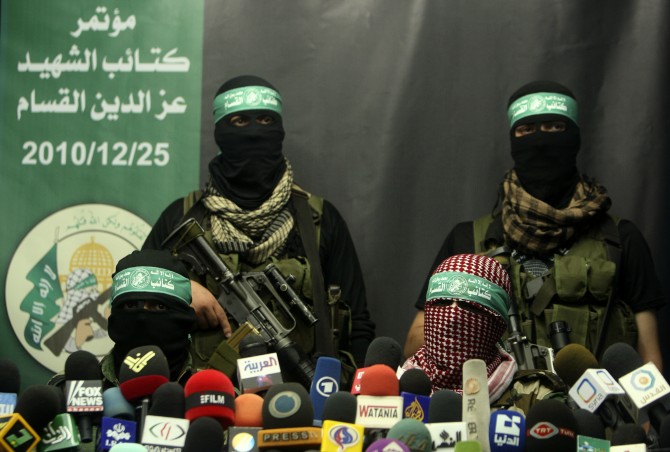 Members of Al-Qassam brigades, the armed wing of the Hamas movement, take part in a news conference in Gaza City