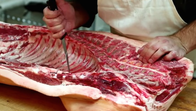 Butcher Cuts Up Pig