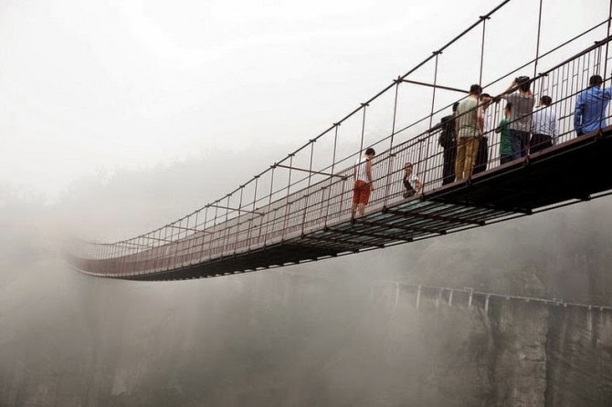 China - glass-bottomed suspension bridge in the mist