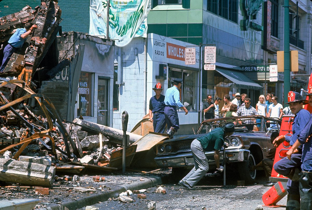 Firemen and civilians starting to clear debris the morning