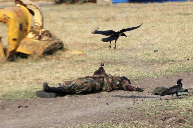 The body of a dead soldier lies on a street in Malakal