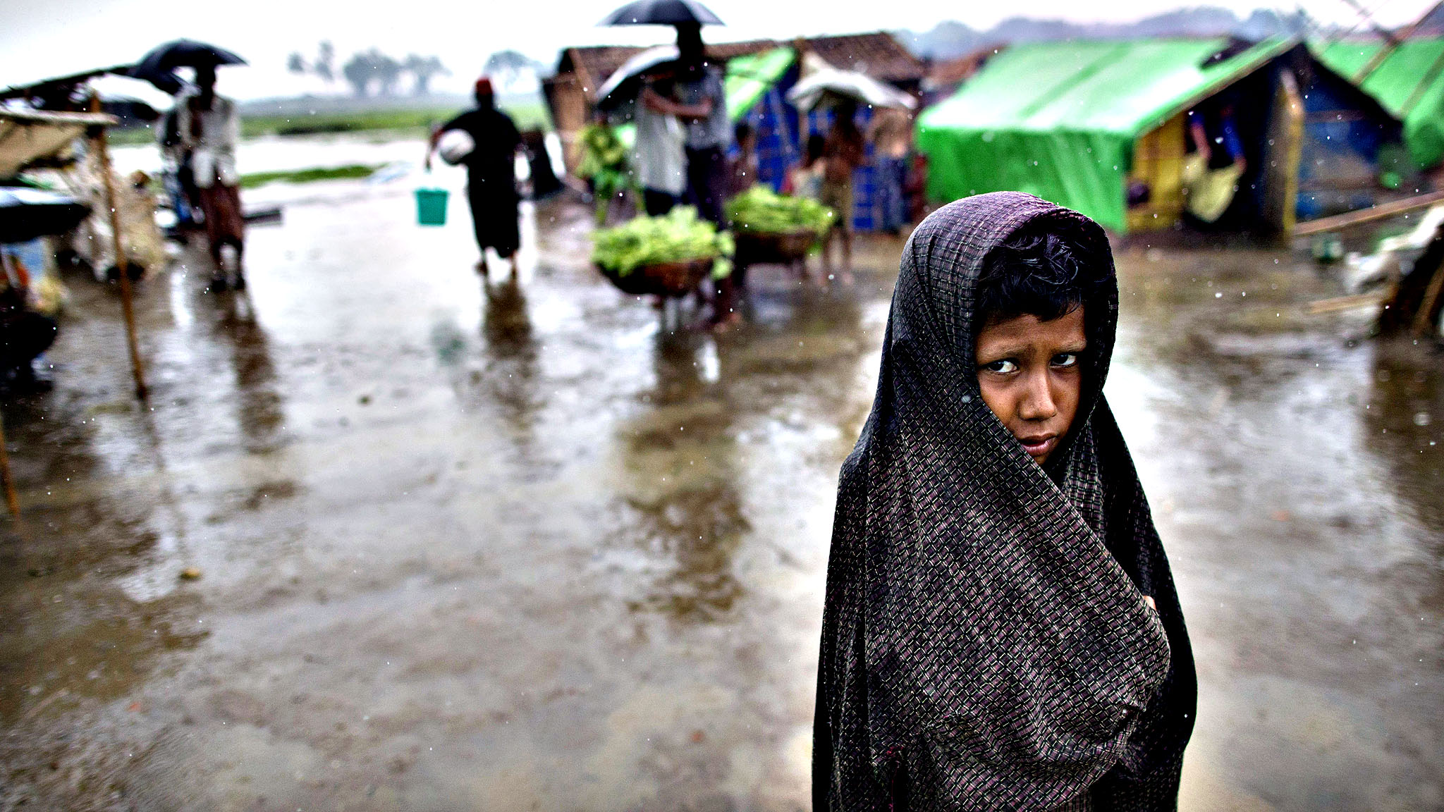 An internally displaced Rohingya boy wraps himself with a sarong