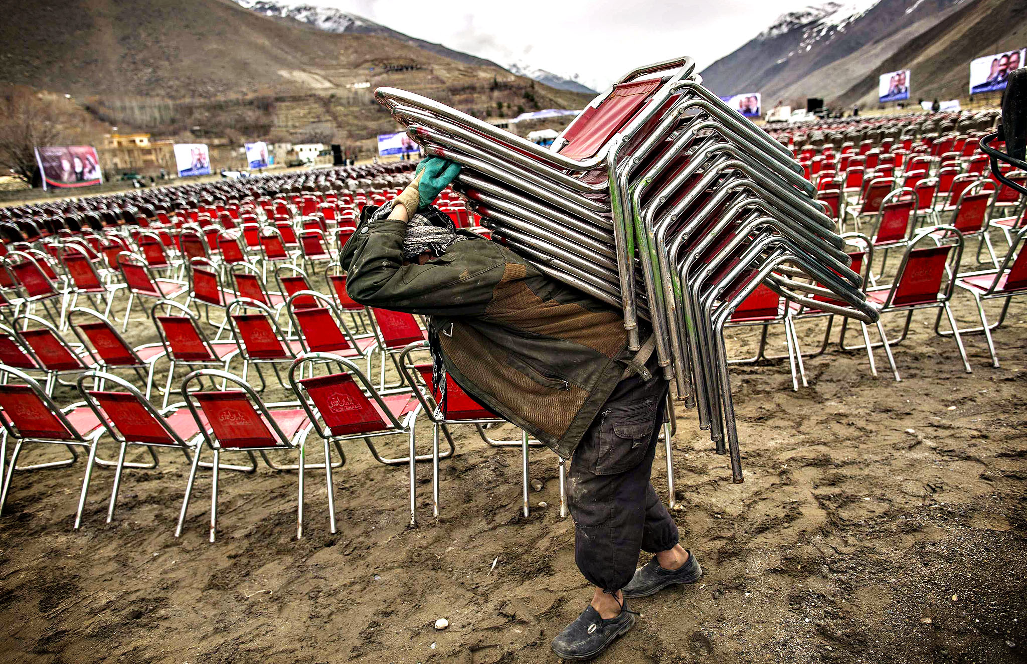 A supporter of Afghan presidential candidate Rassoul carries cha