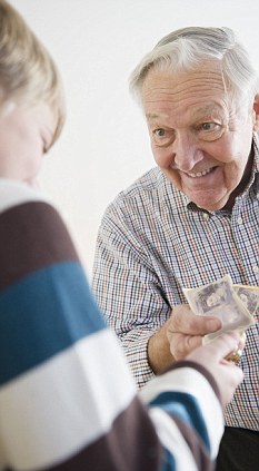 Grandson (8-9) receiving allowance from Grandfather