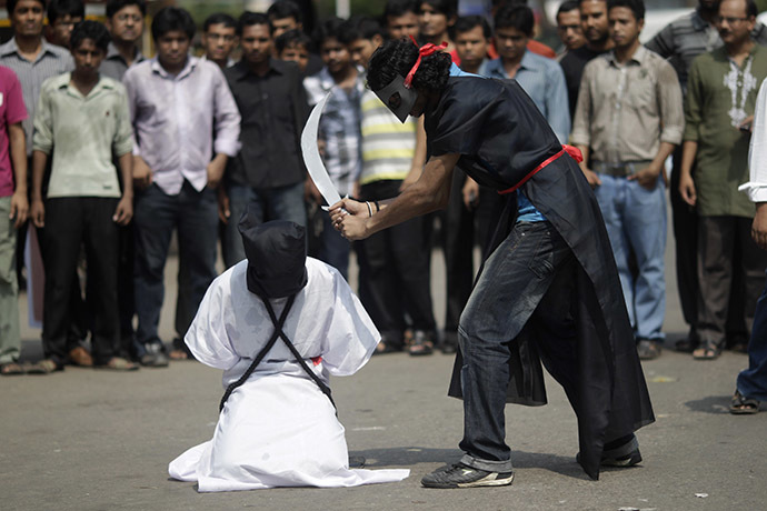 Members of Magic Movement, a group of young Bangladeshis, stage a mock execution scene in protest of Saudi Arabia beheading of eight Bangladeshi workers in front of National Museum in Dhaka