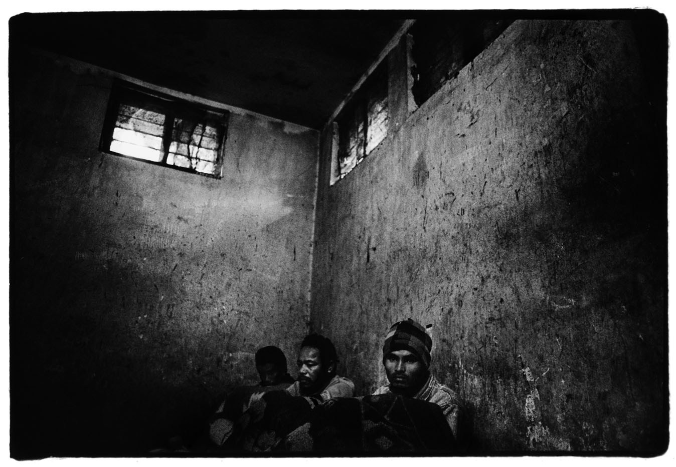 A group of poachers who have been arrested in the Chitwan National Park sit in a jail at the Kasara Royal Nepalese Army barracks.