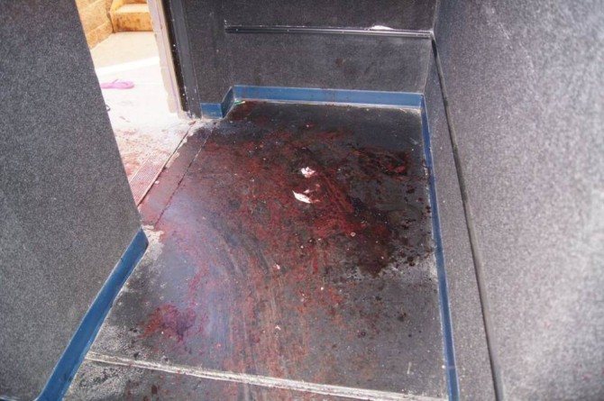 This July 2012 evidence photo, which the Arapahoe County District Attorney's Office released in response to open-records requests, shows blood at an exit of the theater following the July 20 shooting by James Holmes, in Aurora, Colo. In August 2015, Holmes was sentenced to life in prison because jurors could not agree that he deserved the death penalty. (Arapahoe County District Attorney's Office via AP)