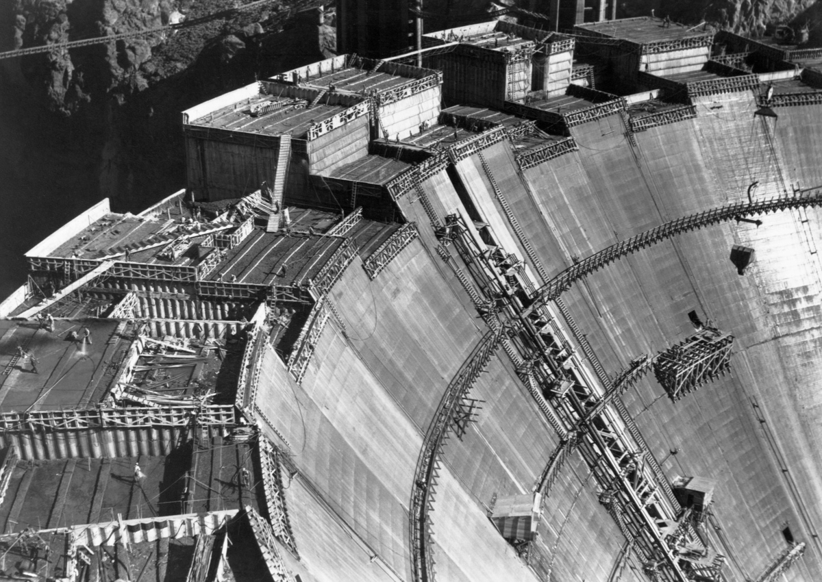 1934, Boulder City, Nevada, USA --- Construction continues atop Boulder Dam. Now called Hoover Dam, it is one of the world's largest dams, holding back the waters of the Colorado River between Arizona and Nevada to create power and Lake Mead. Nevada. --- Image by © CORBIS