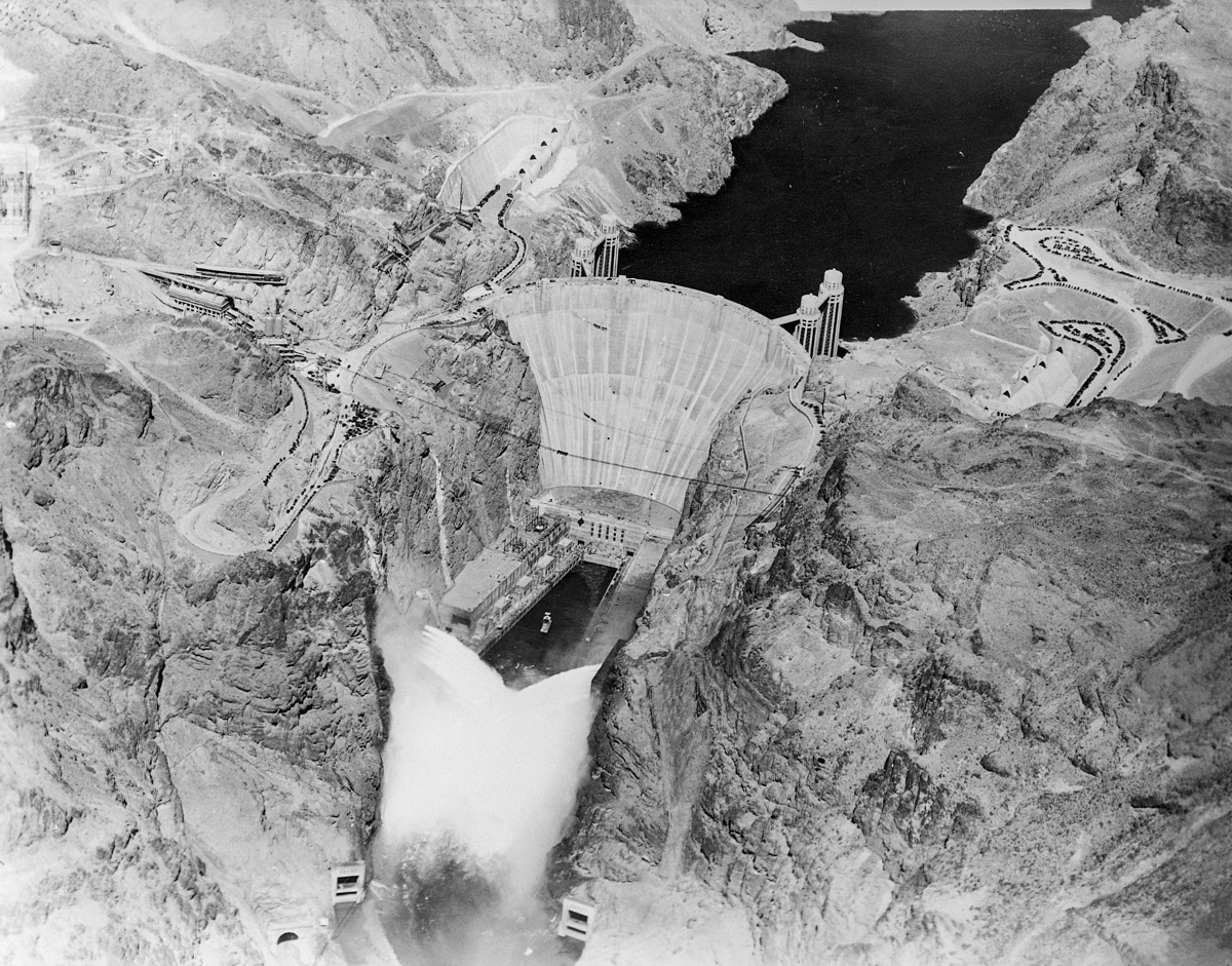12 Sep 1936, USA --- Original caption: 9/12/1936-Boulder Dam, AZ/NV- An electrical impulse released by President Roosevelt pressing a button across the continent sent 3,600,000 cubic feet of water a minute tumbling through Gigantic Boulder Dam, and put the Colorado River to work generating electrical power. This photo made by Albert Kopec from a Richfield Oil Company plane, shows the Niagara of water from the 12 outlets; six on the Nevada side and six on the Arizona side. --- Image by © Bettmann/CORBIS