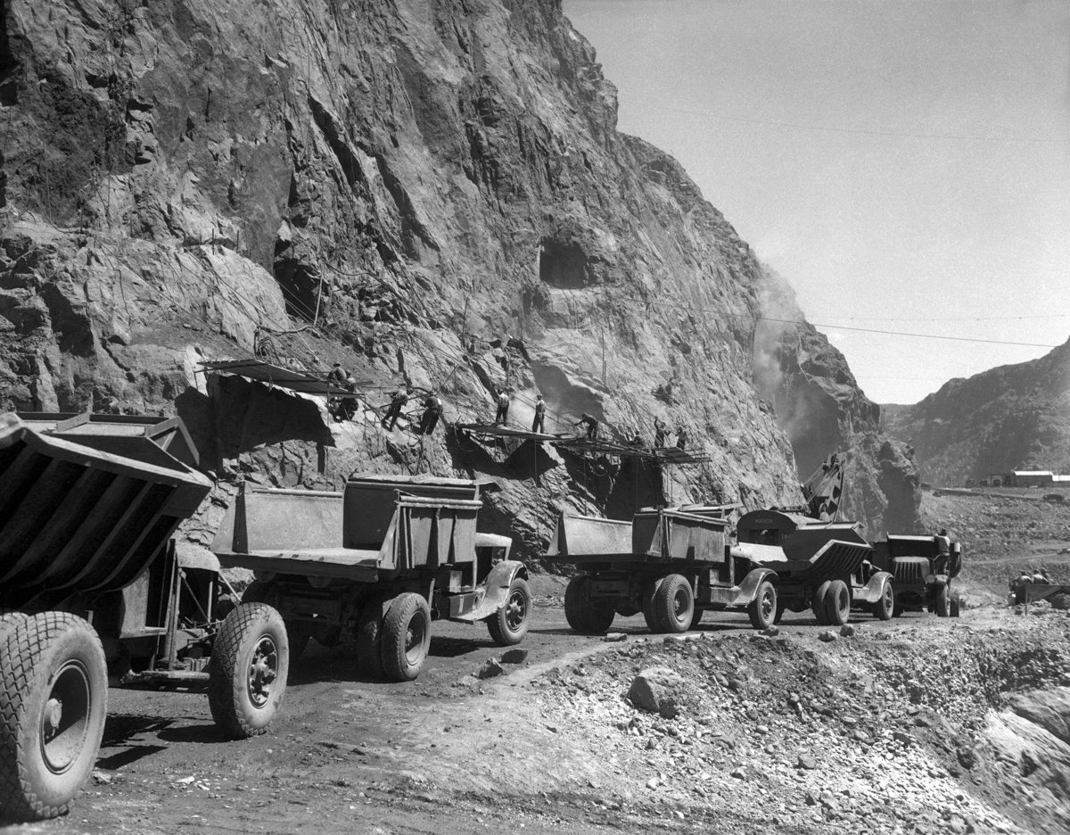 1933, Boulder City, Nevada, USA --- Original caption: 1933-Boulder City, CO- Picture shows dump trucks driving along the side of a mountain where men on working on construcing the Boulder Dam (known now as thew Hoover Dam).--- Image by © Bettmann/CORBIS