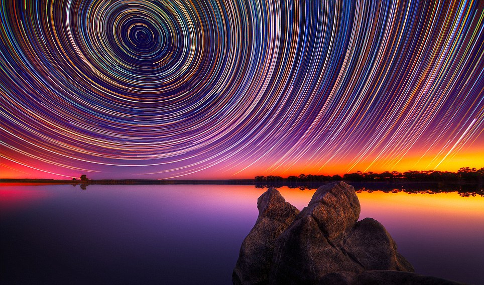 PIC BY LINCOLN HARRISON / CATERS NEWS - Photographer Lincoln Harrison was really shooting for the stars with this spectacular collection of snaps. His unrivalled pictures of star trails were taken over a period of up to 15 hours in Bendigo, Australia over the scenic Lake Eppalock. Captured using a long exposure lens, the trails are created as the Earth rotates, giving the impression of the stars moving across the sky. Lincoln, 36, bought his first camera last year to take pictures of clothes he wanted to sell on eBay. SEE CATERS COPY.