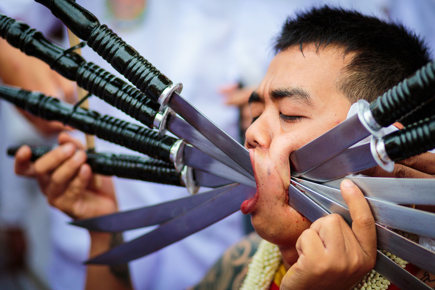 Extreme piercing performed at Phuket Vegetarian Festival parade