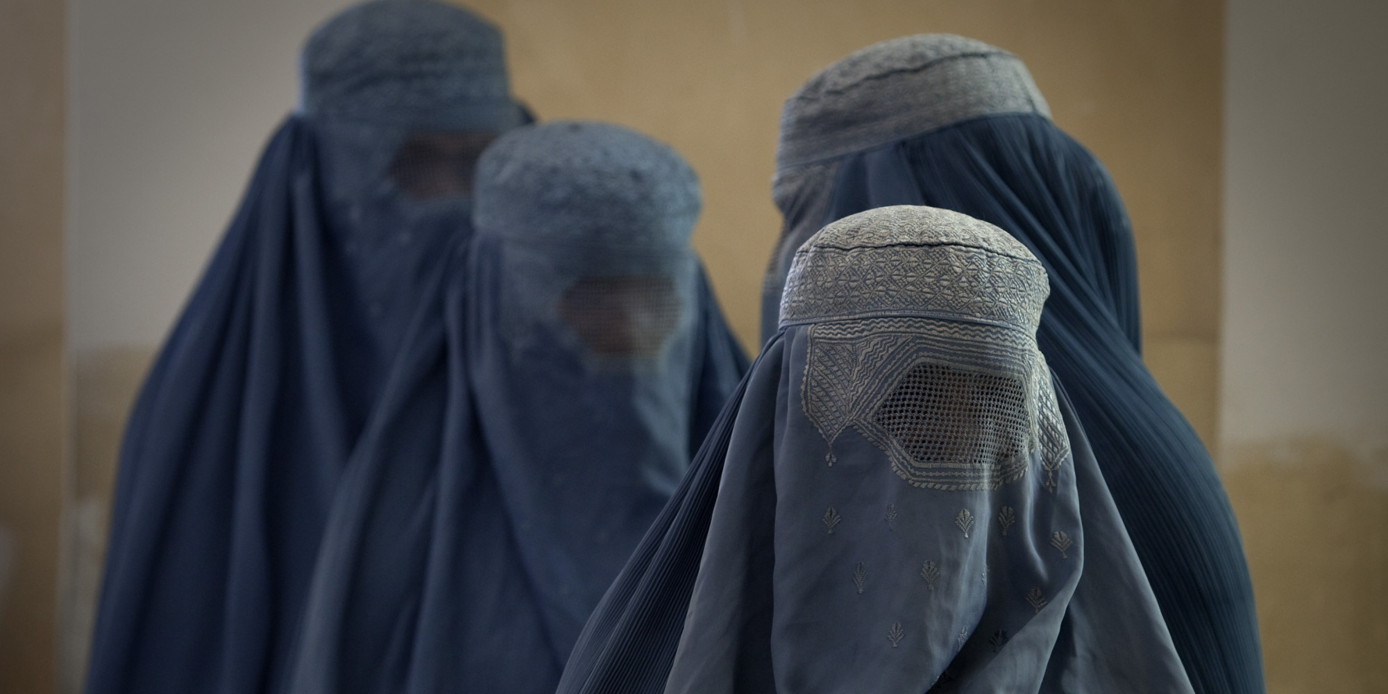 KABUL, AFGHANISTAN -AUGUST 20 : Afghan women in burqas wait in line at a polling station on August 20, 2009 in Kabul, Afghanistan. Afghans voted on Thursday to elect a president for the second time in history with election officials stating that turnout was healthy despite sporadic violence by the Taliban. The incumbent President, Karzai is considered to be the frontrunner despite claims of corruption and what many consider an ineffectual government. (Photo by Paula Bronstein/Getty Images)