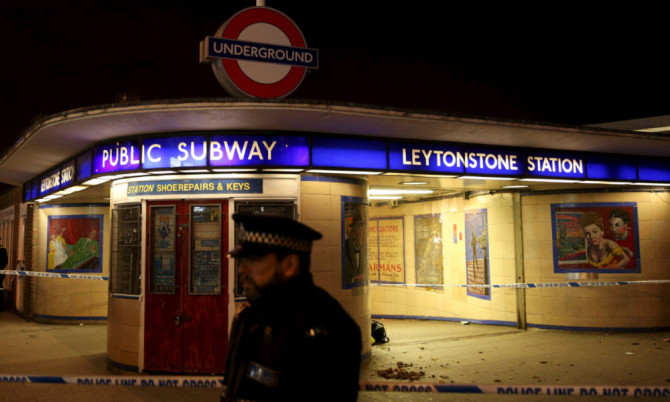 Police officers investigate a crime scene at Leytonstone underground station in east London