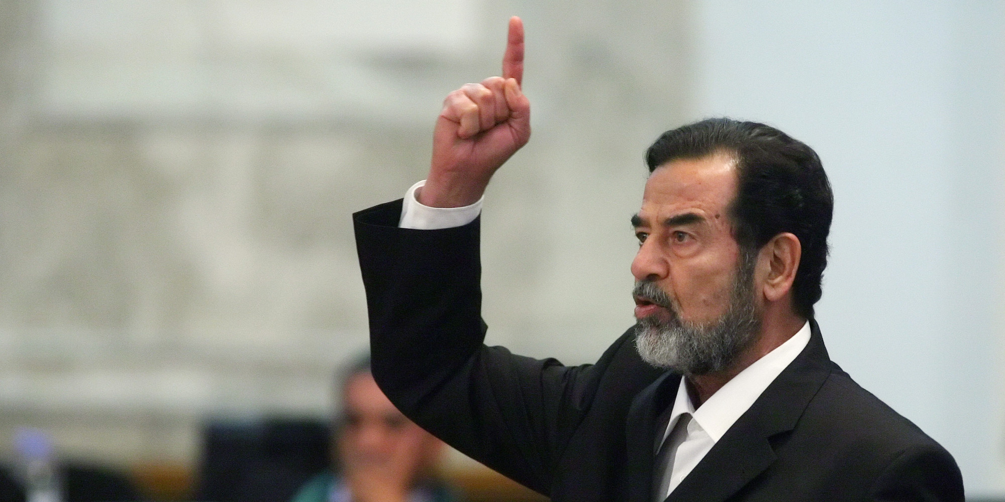 Former Iraqi president Saddam Hussein reacts as the verdict is delivered during his trial held under tight security in Baghdad's heavily fortified Green Zone, Sunday Nov. 5, 2006. Iraq's High Tribunal on Sunday found Saddam Hussein guilty of crimes against humanity and sentence him to die by hanging. (AP Photo/Scott Nelson, Pool)