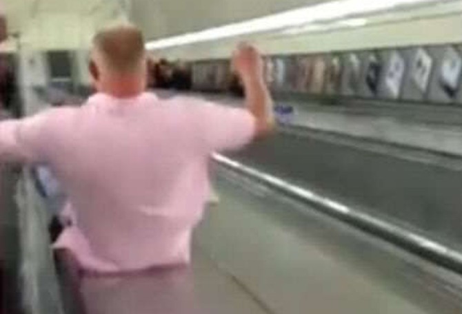 Guy Sliding Down Escalator