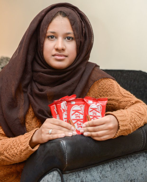Saima Ahmad holding four KitKats, Saima is so furious she has¿demanded a lifetime supply of¿KitKat¿bars¿and threatened legal action against NestlÃˆ¿after she discovered that some of the chocolate fingers in her multipack contained no wafer and were just pure chocolate.¿ Enfield, London See SWNS story SWKITKAT; A furious woman is demanding a lifetime supply of chocolate under threat of legal action - after getting eight KitKats with no WAFER. Saima Ahmad (corr) was so enraged that she wrote a strongly worded letter to manufacturer Nestle explaining her disappointment and even quoted case law from the 1930s to back up her case. The 20-year-old law student from Enfield, north London, bought a multipack of eight KitKat from her local supermarket for £2 last month to share with her friends. Whinging Saima, a second year law student at Kings College London, feels misled by the company and believes that they have ignored their duty of care to consumers. The massive complainer said: "They go about advertising the unique concept of KitKat, but I'm so disappointed by what I have purchased.