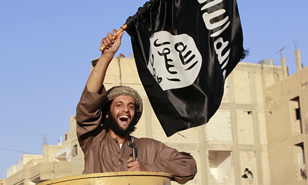 An Isis fighter takes part in a military parade