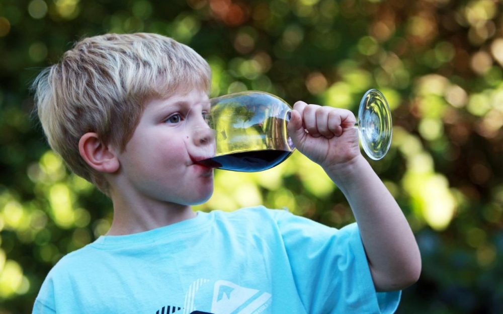 Kid drinking wine