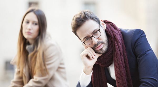 Portrait of young woman and man outdoor on street having relatio