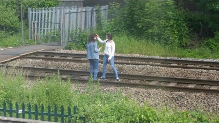 teen girls train track selfie