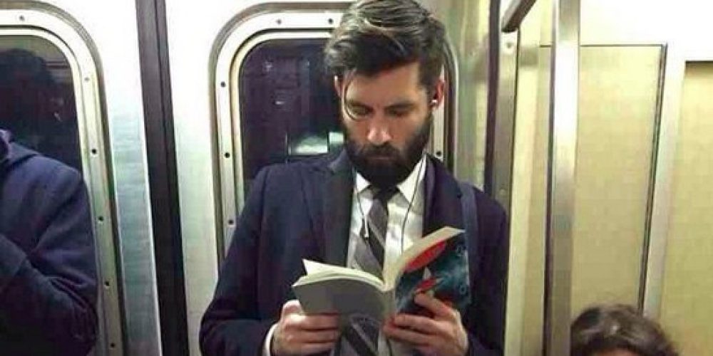 Man Reading On Tube