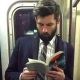 Man Reading On Tube