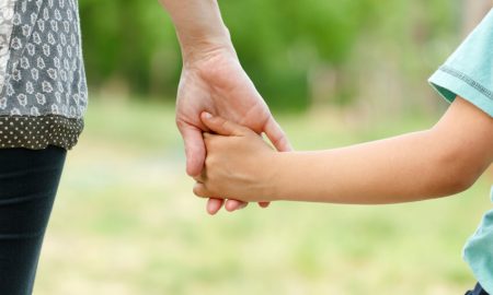 Parent holding child's hand