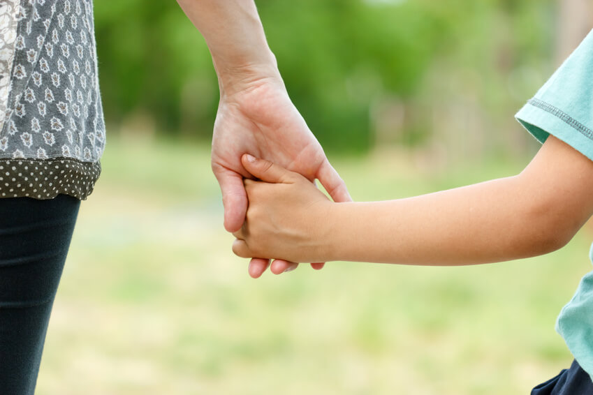 Parent holding child's hand