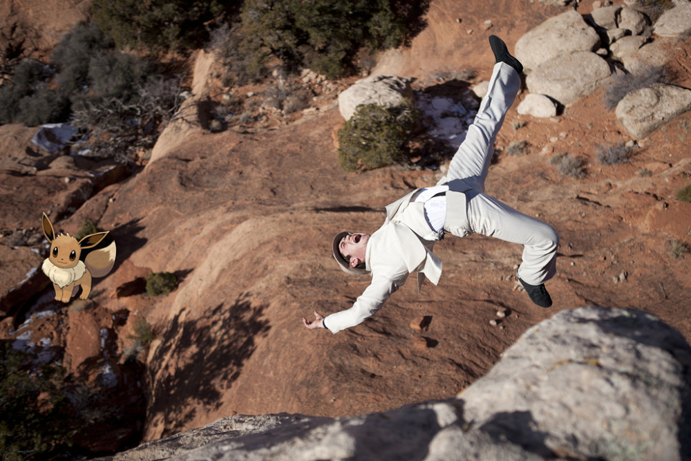 Man in pinned stripe suite falling off a cliff.