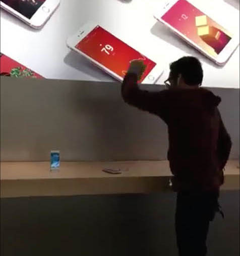 Man smashing iPhones