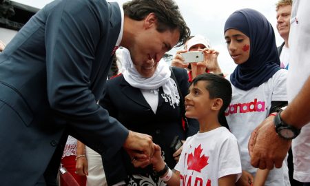 Canada's PM Trudeau shakes hands with a Syrian refugee during Canada Day celebrations on Parliament Hill in Ottawa